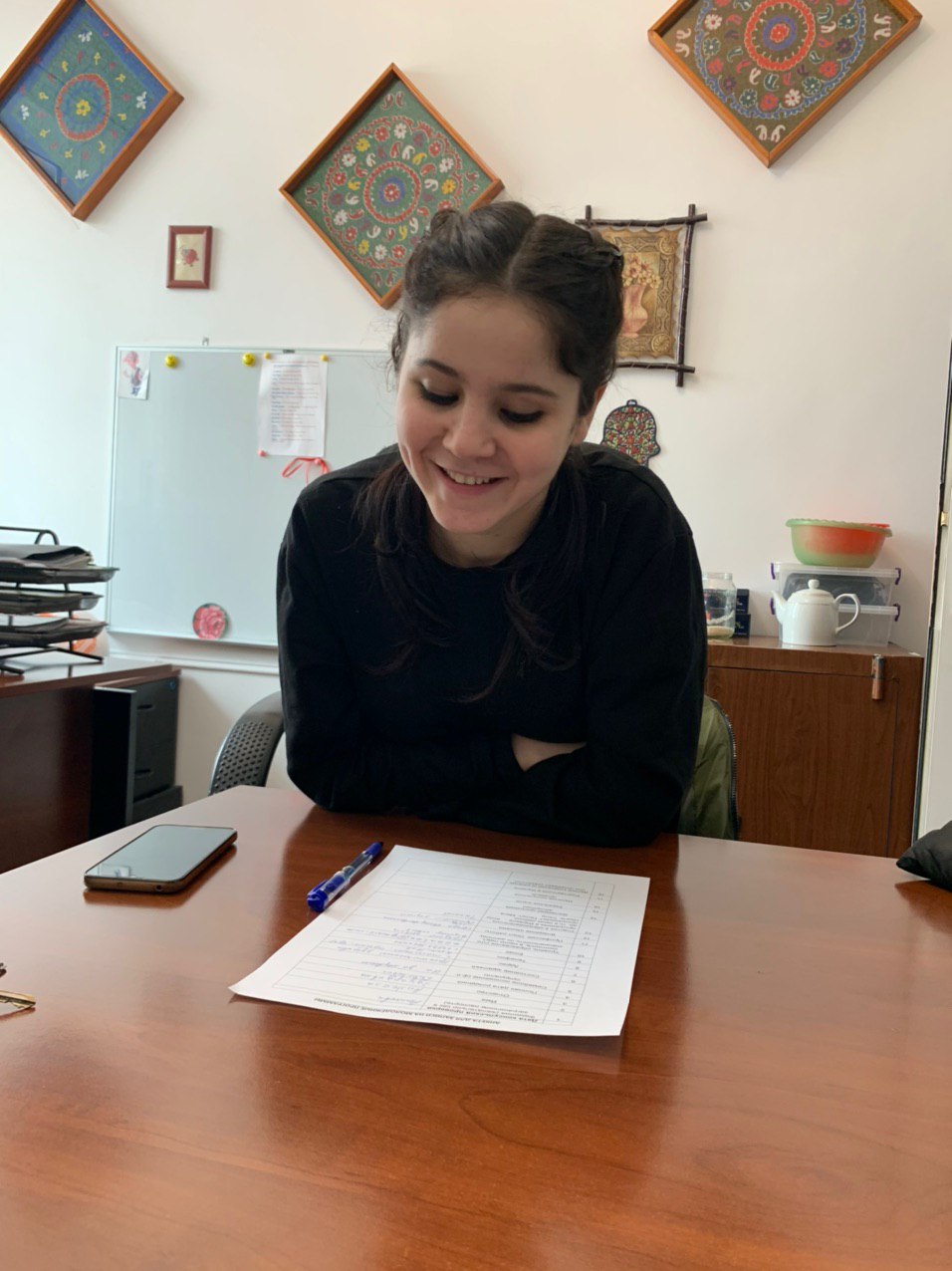 Image of Maria sitting at a desk